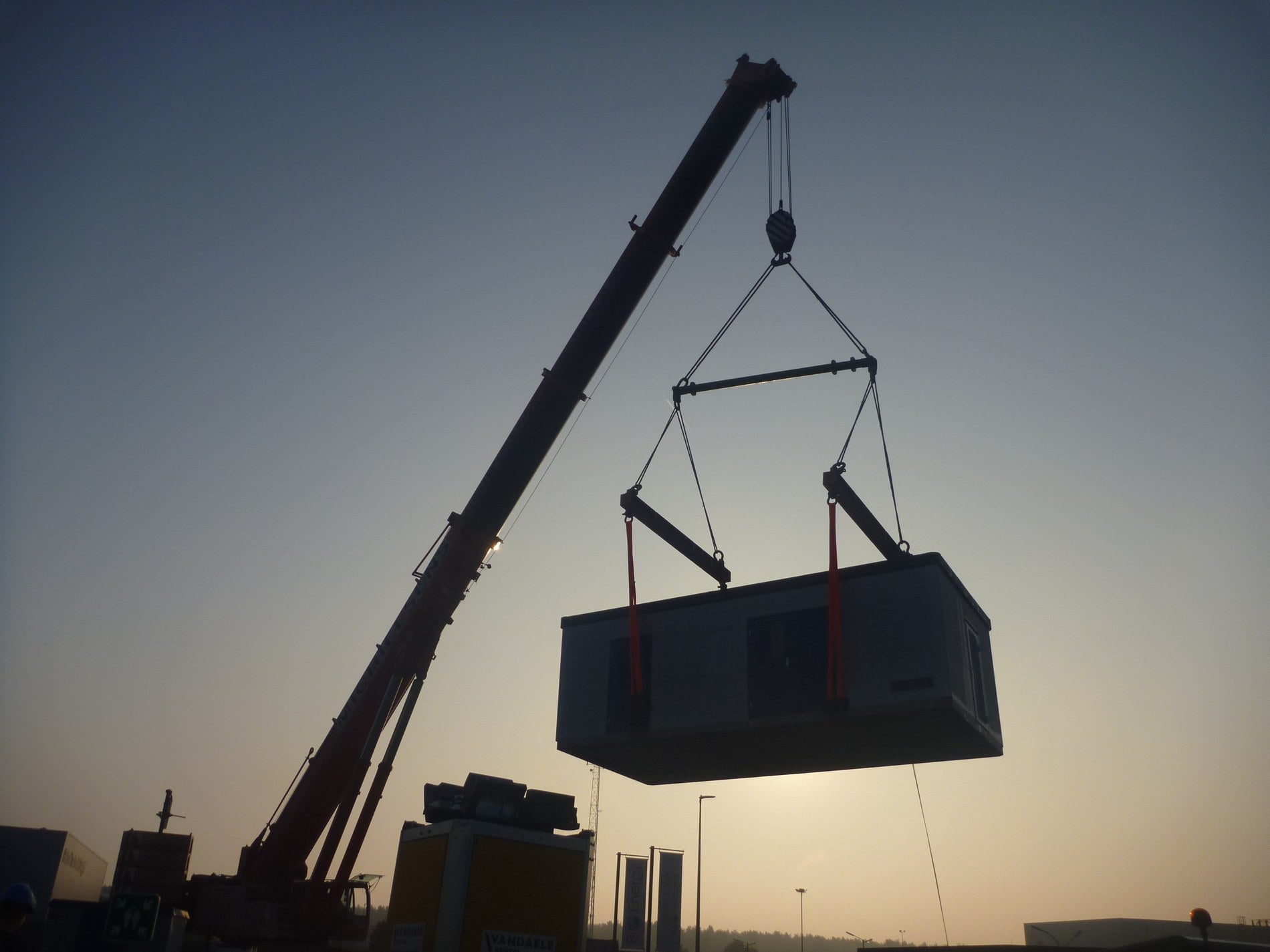 Prefabricated NORDKAP compressor station lifted by crane during installation on site
